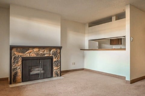 an empty living room with a fireplace in it