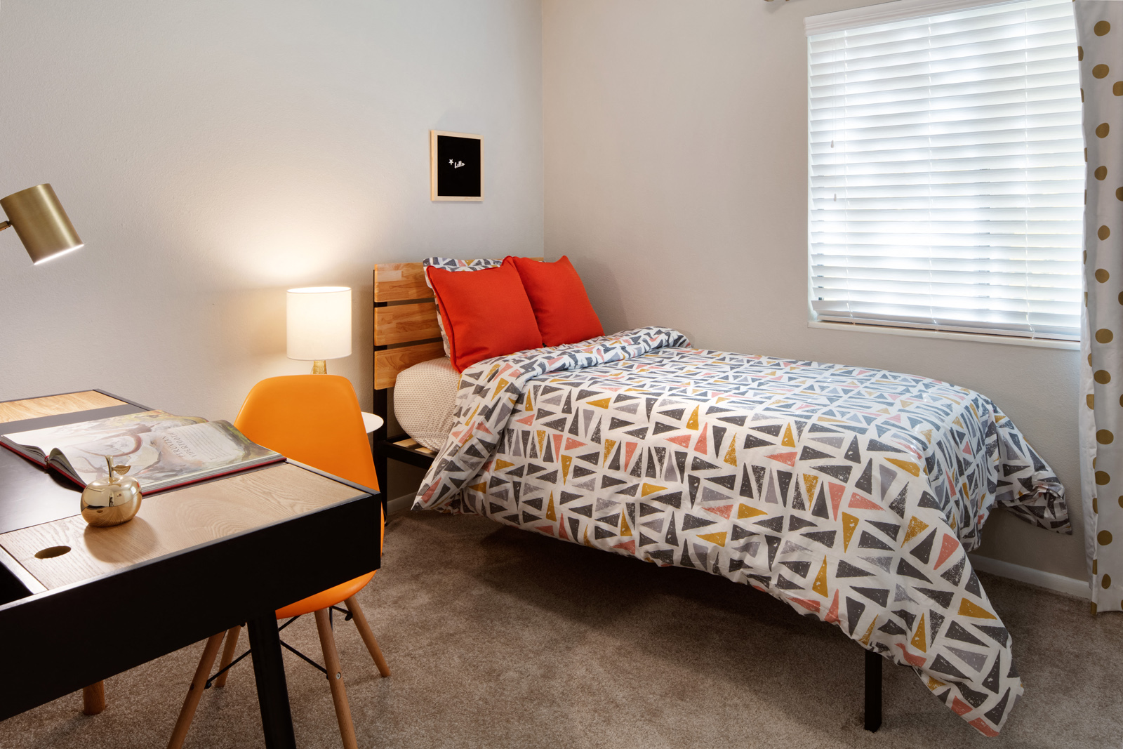Bedroom with geometric bedding and workspace desk at Clover Creek Apartments, Murray, UT 84123