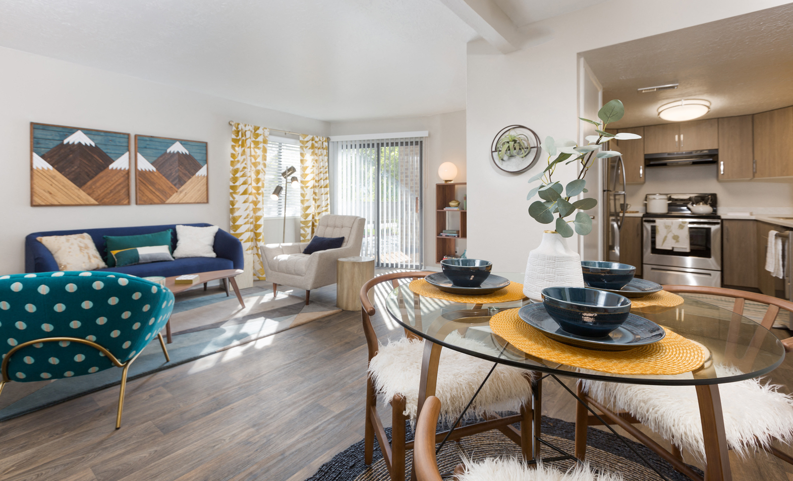 a living room and kitchen with a dining room table and chairs