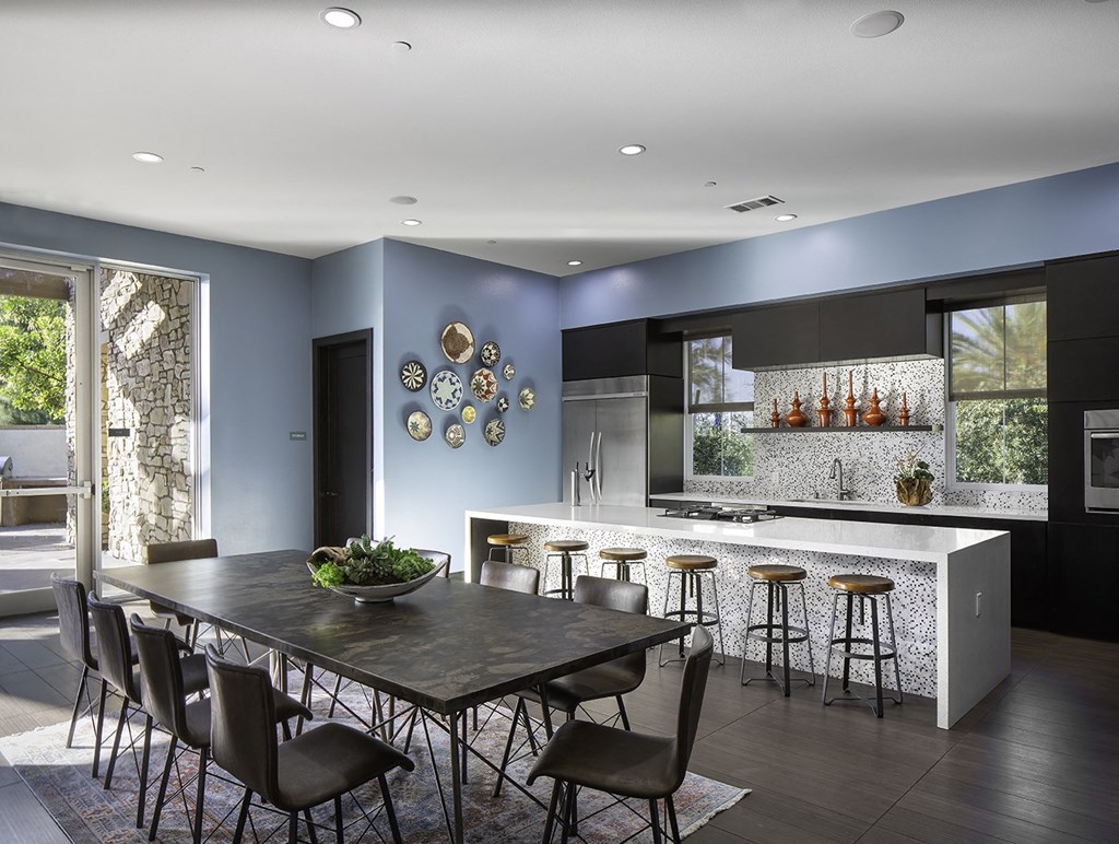 a kitchen with blue walls and a table and chairs