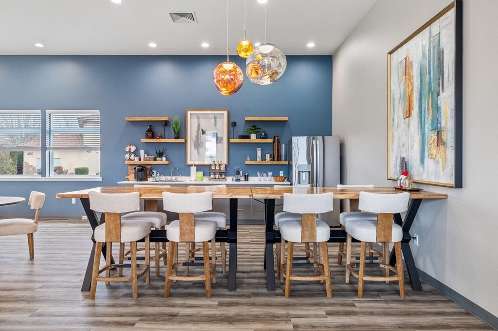 A dining room with a table set for six.