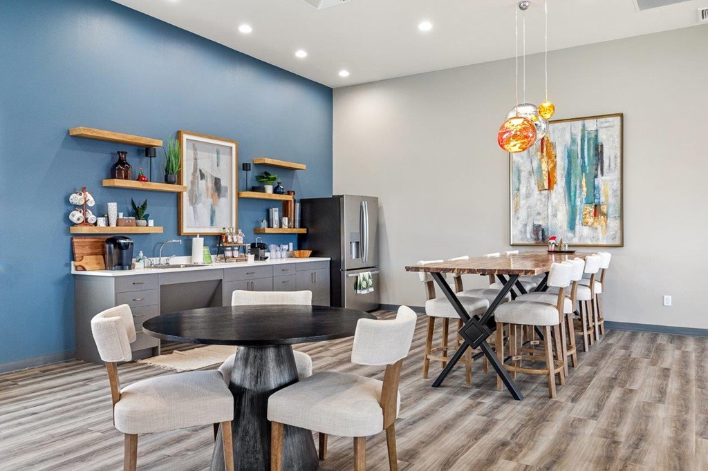 A modern kitchen with a dining table and chairs.