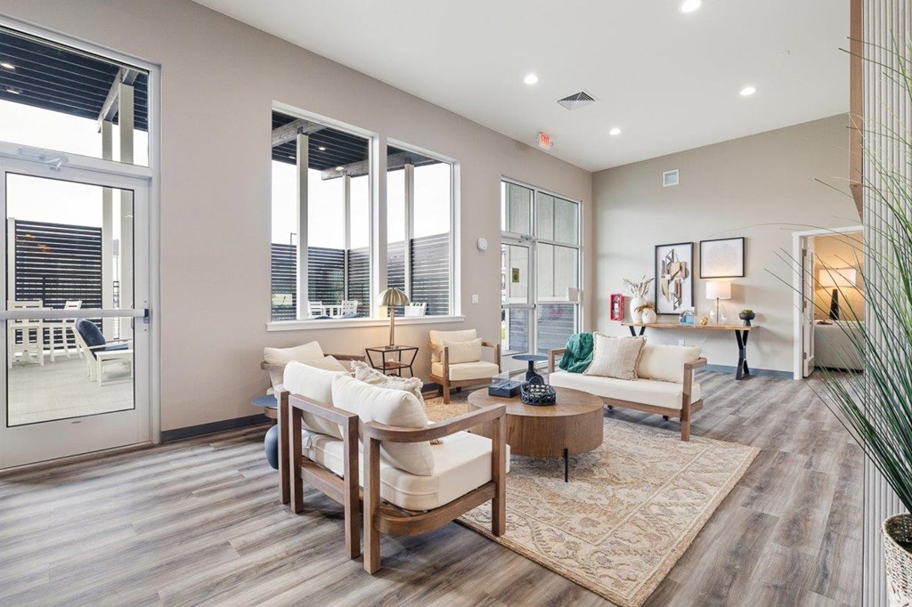 A living room with a white couch and a wooden coffee table.