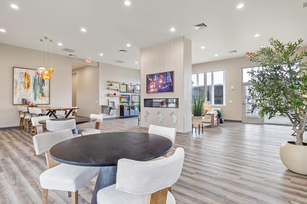 A modern dining room with a large table and chairs.