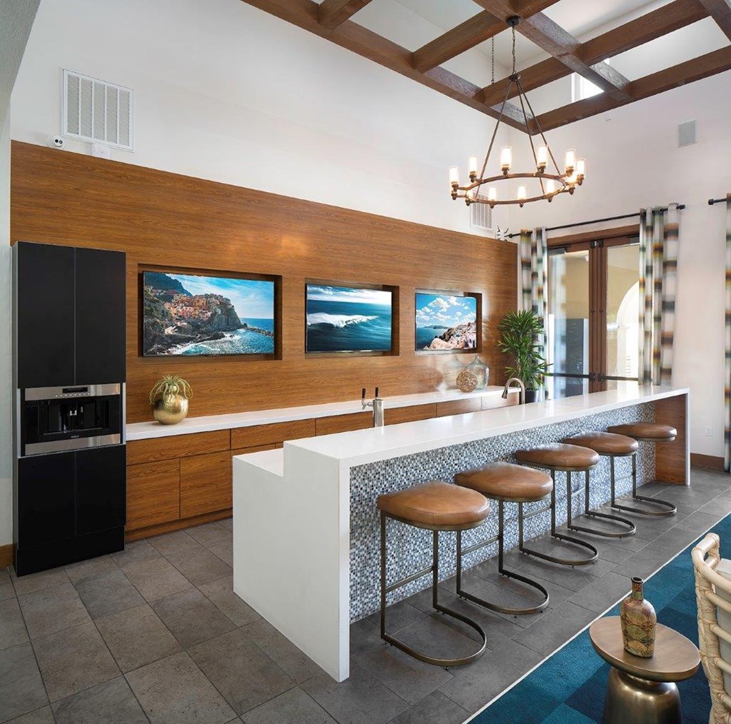a kitchen with a long counter and stools