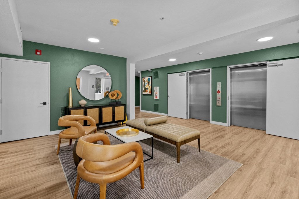 a living room with green walls and sliding glass doors
