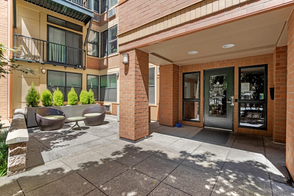 the preserve at ballantyne commons apartment entrance with patio and chairs