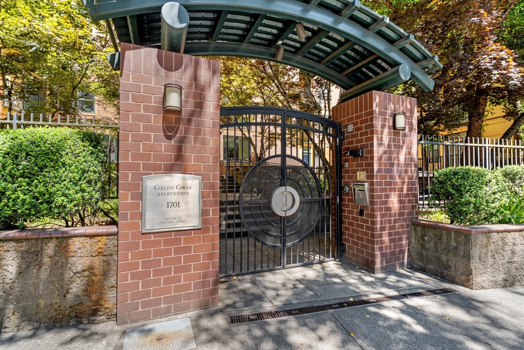 a gate to a park with a brick gate