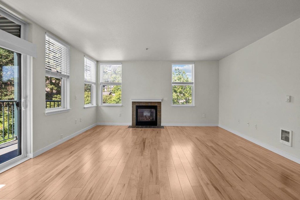 a living room with a fireplace and wooden floors
