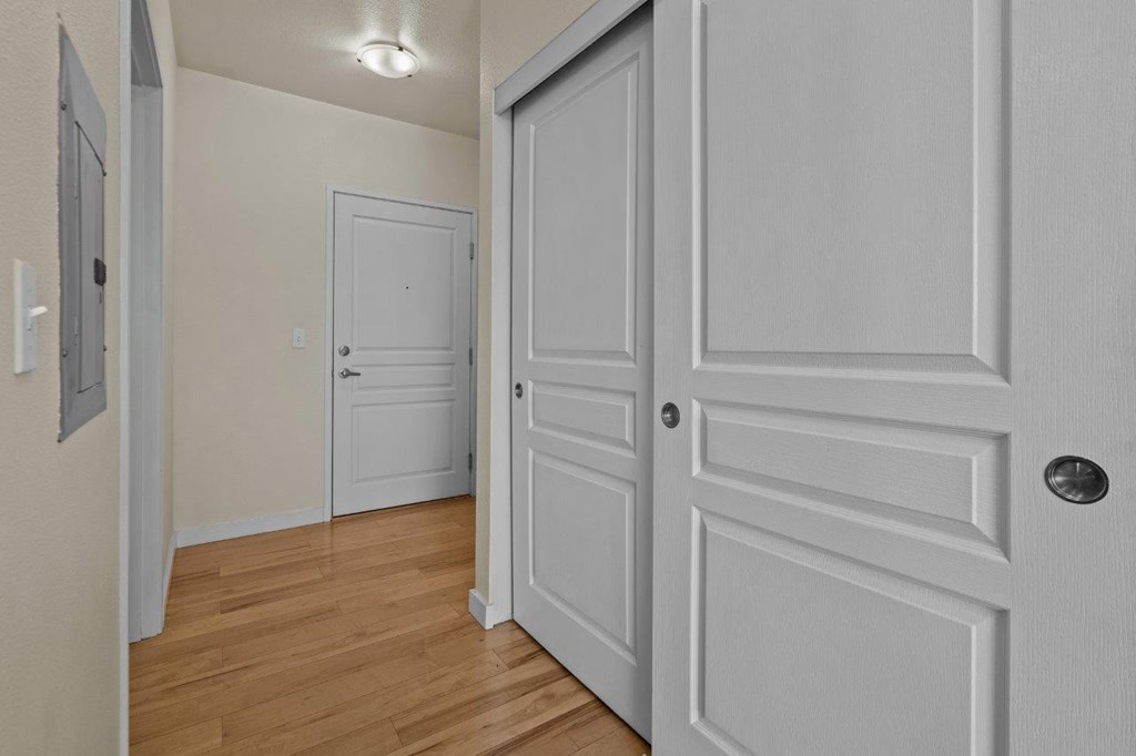 a bedroom with white doors and a door to a closet