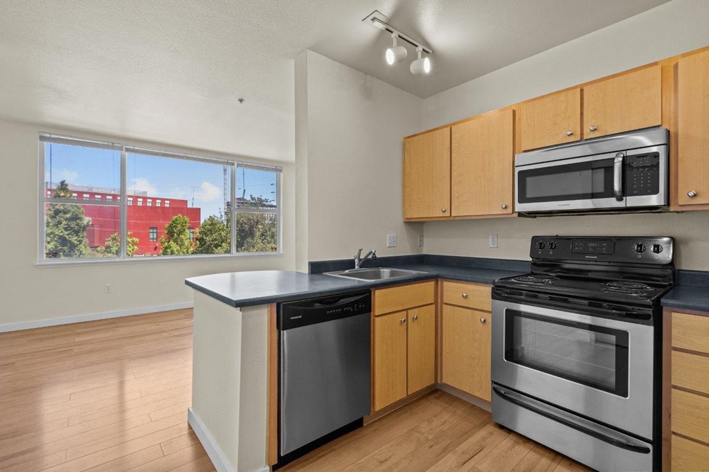 a kitchen with stainless steel appliances and wooden cabinets