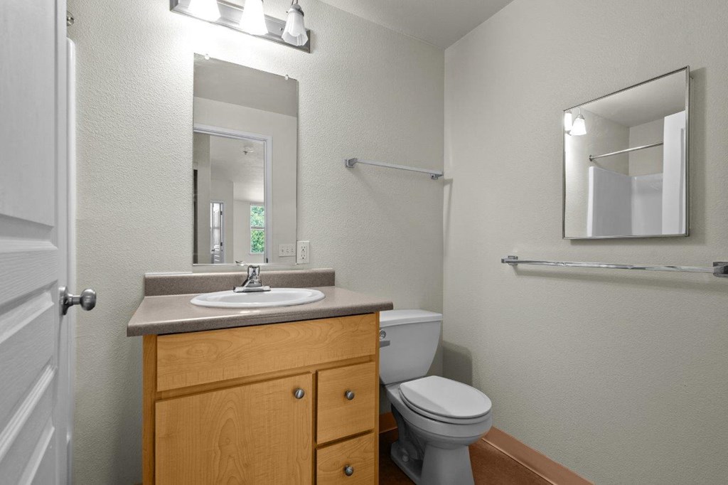 a bathroom with a sink toilet and a mirror