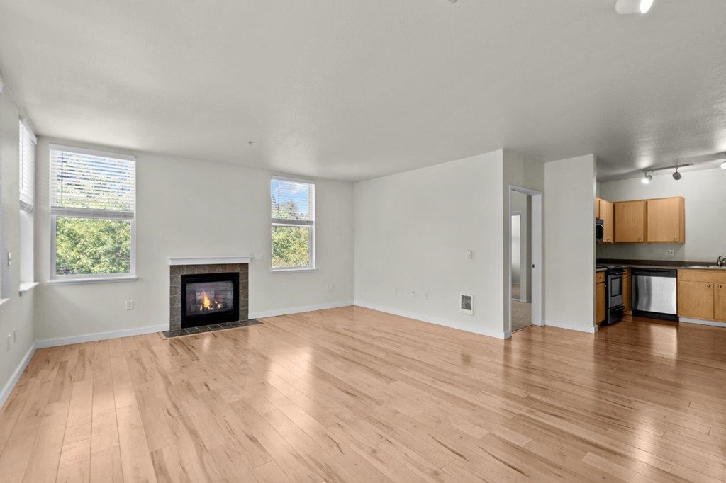 a living room with a fireplace and wooden floors