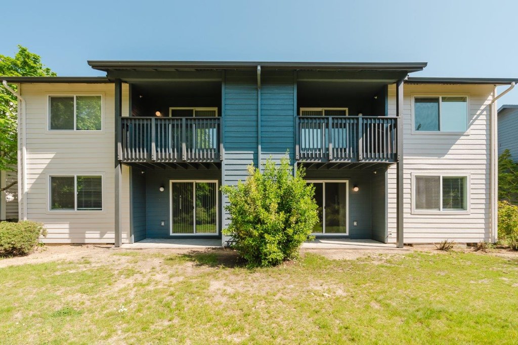 A two-story house with a balcony on the second floor.