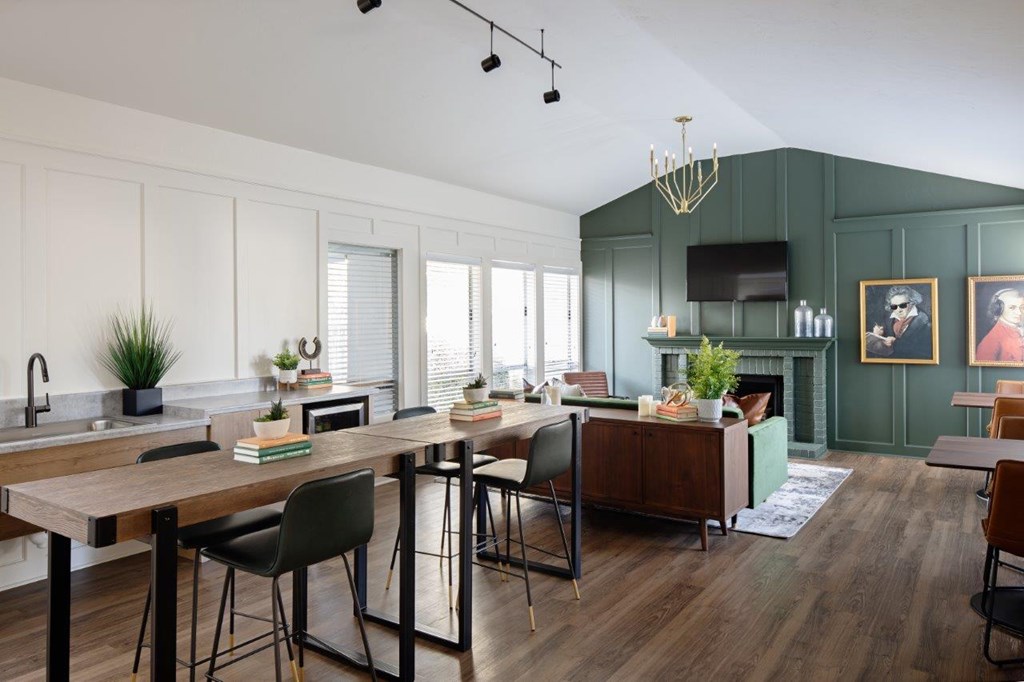 A modern kitchen with a wooden table and chairs.