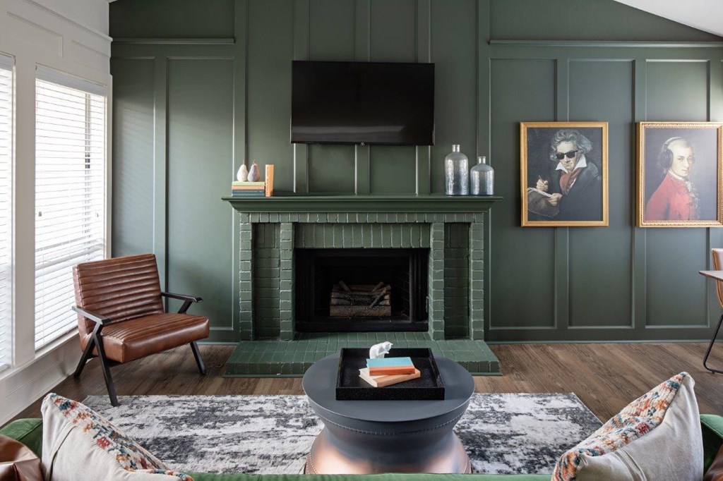 A living room with a fireplace and a chair.