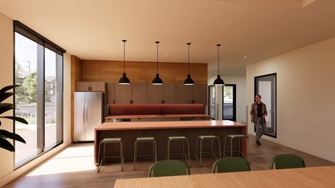 A modern kitchen with a long table and chairs.