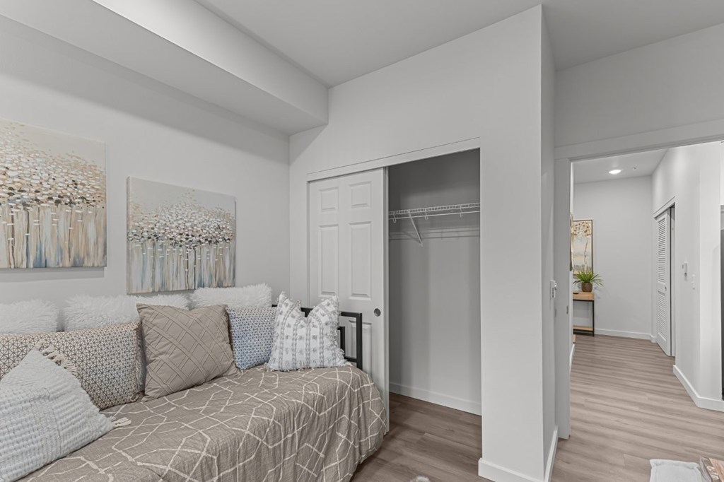 A bedroom with a bed and a painting on the wall.