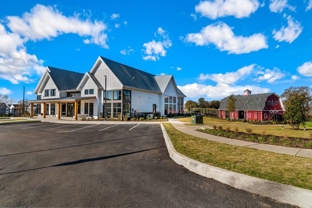 A large building with a parking lot in front of it.