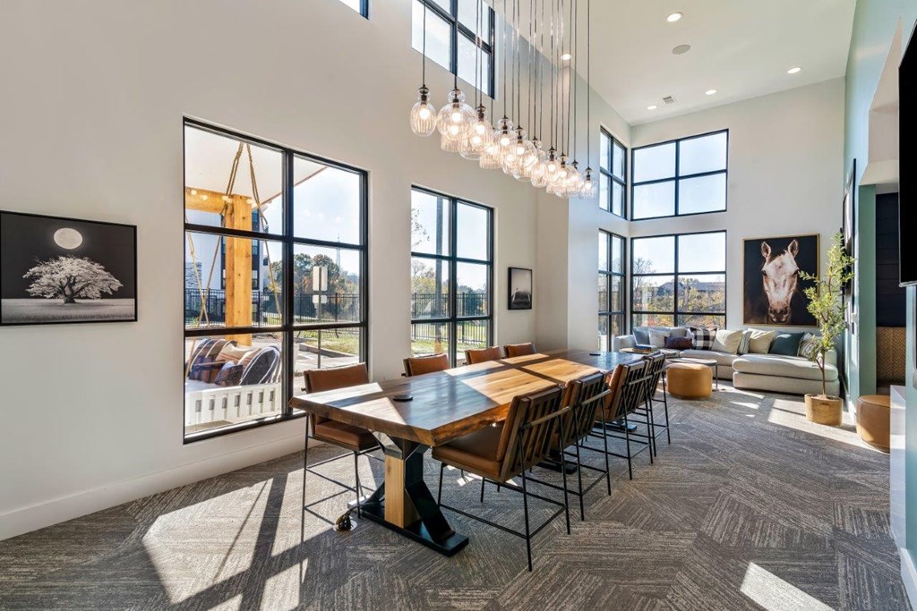 A modern dining room with a large table and chairs.
