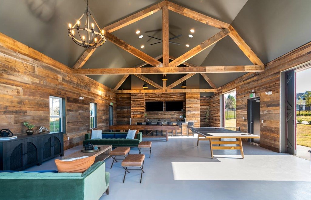 A wooden log cabin interior with a large open floor plan.