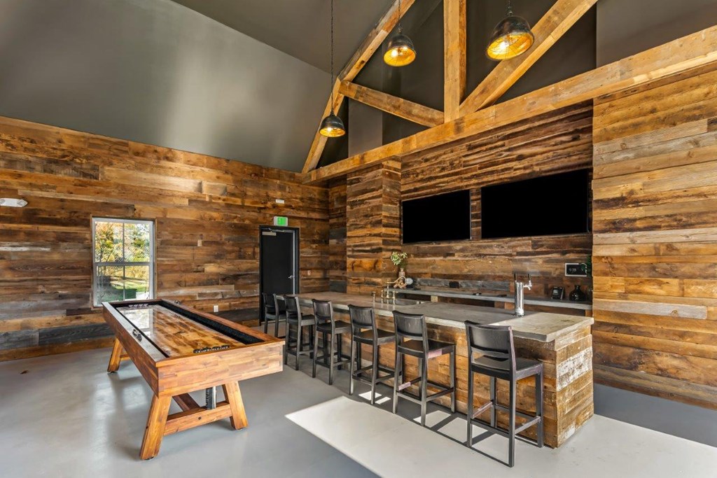 A room with wooden walls and a pool table.