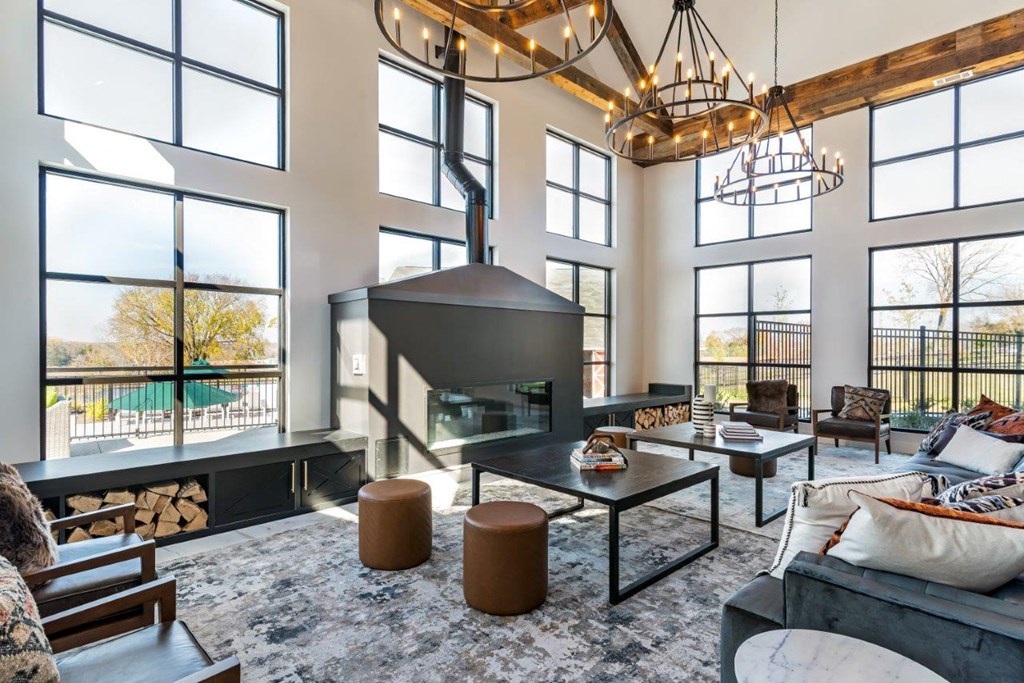 A modern living room with a fireplace and a large window.