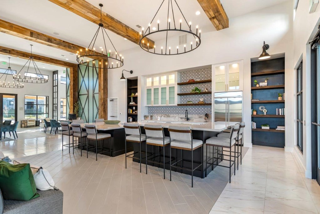 A modern kitchen with a dining area and a living room.