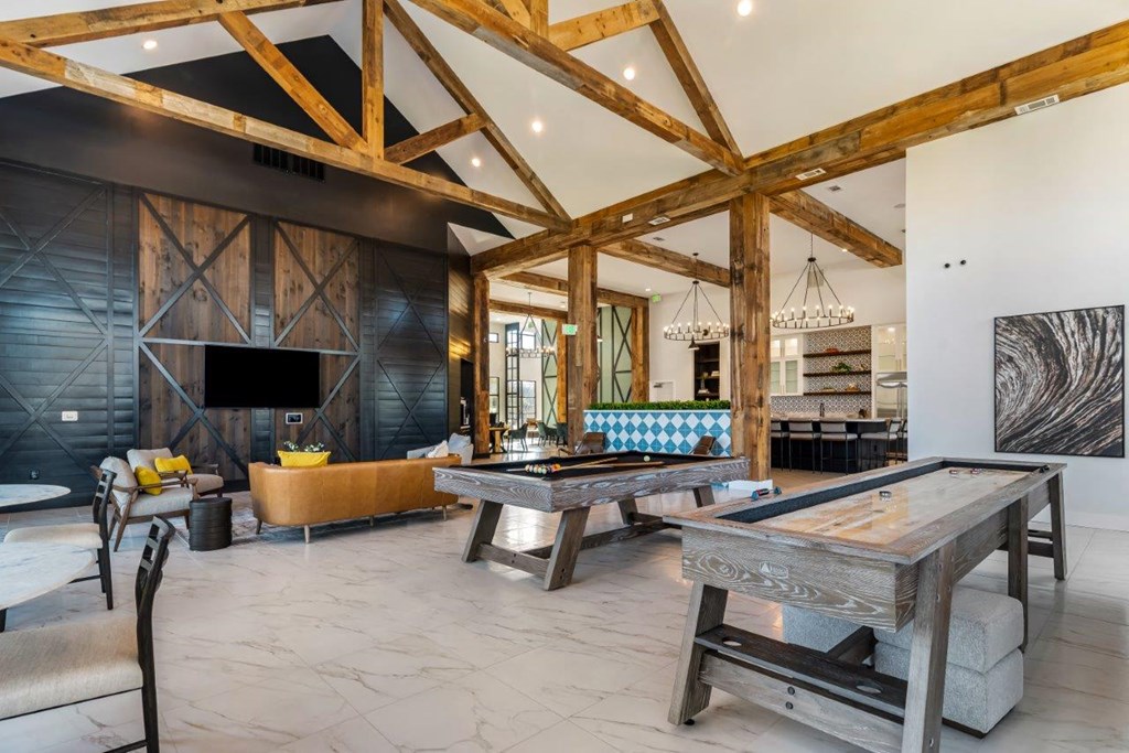 A modern living room with a wooden ceiling and a large coffee table.