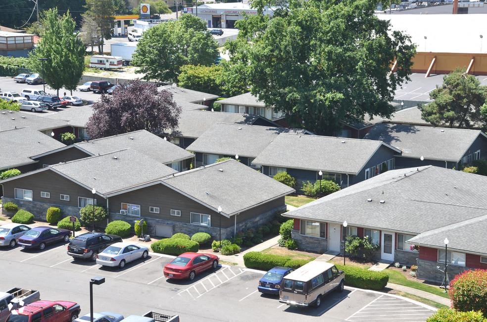an aerial view of a neighborhood with cars parked in a parking lot