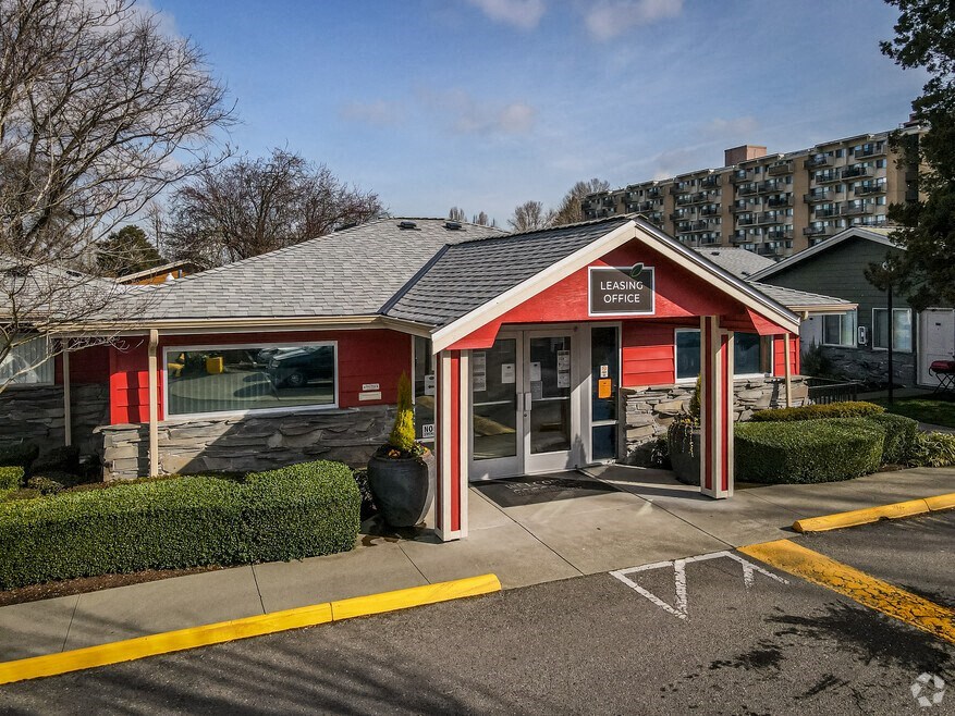 a small red building with a sign on the side of it