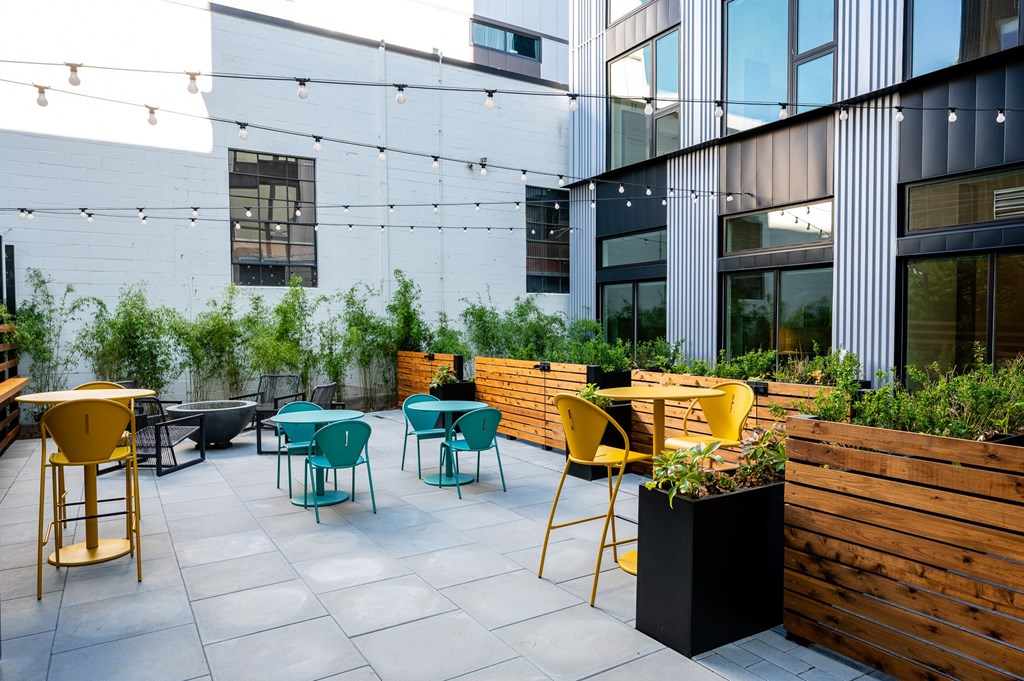 MERX Slabtown's patio featuring tables and chairs is surrounded by a wooden fence for residents to lounge and kick back in Portland, Oregon.