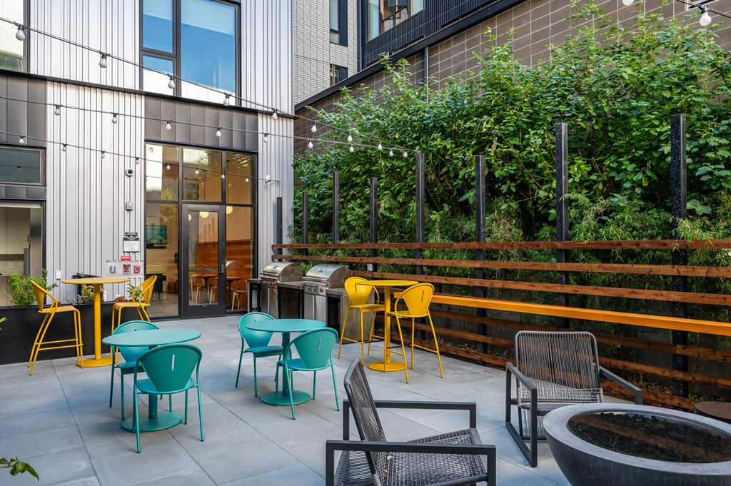 MERX Slabtown's courtyard with a table and chairs is surrounded by a fence.