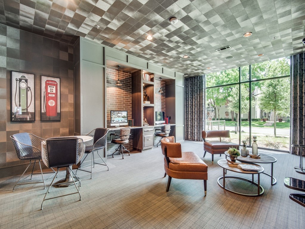 a room with chairs and tables and a large window