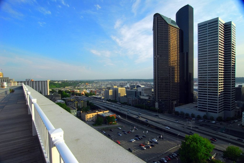 A cityscape with a highway and two tall buildings.