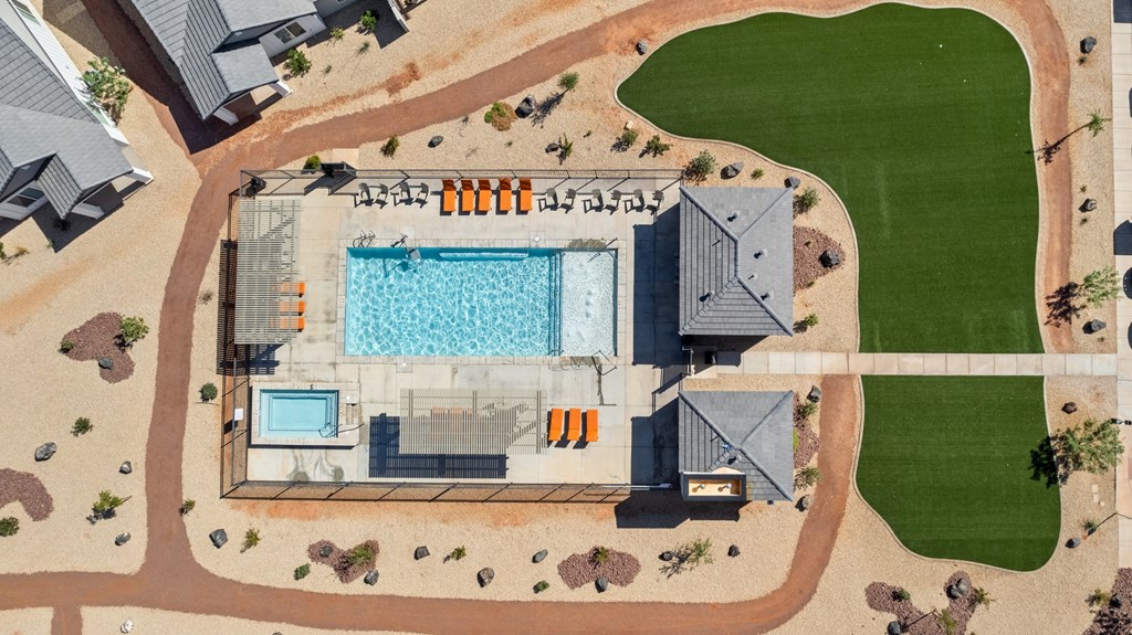 an aerial view of a house with a pool and a lawn