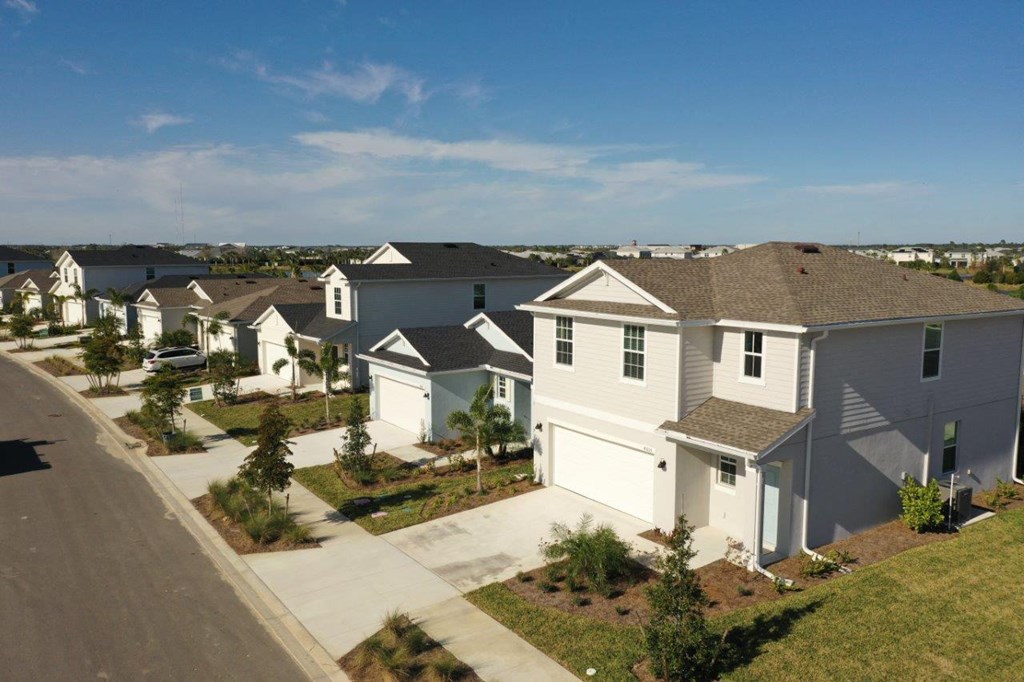 an aerial view of a row of houses on a street