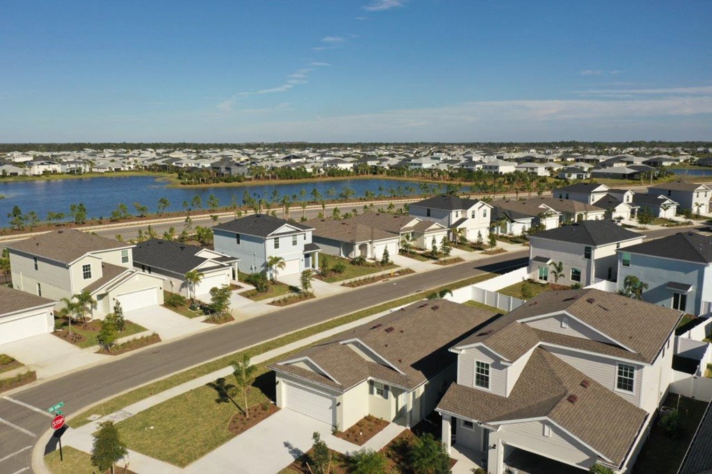 an aerial view of a neighborhood of houses near a lake