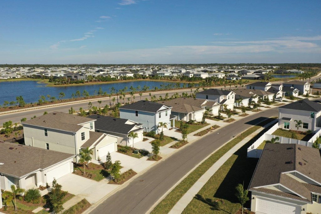 A row of houses with a body of water in the background.