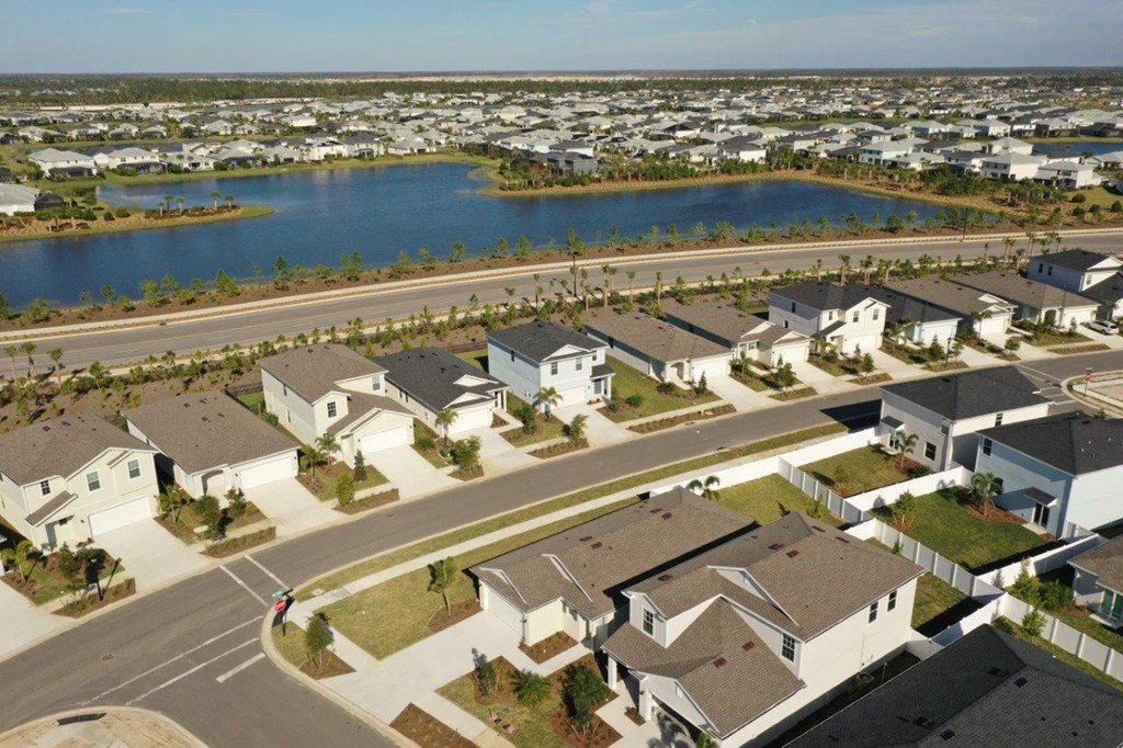 an aerial view of a neighborhood of houses near a body of water