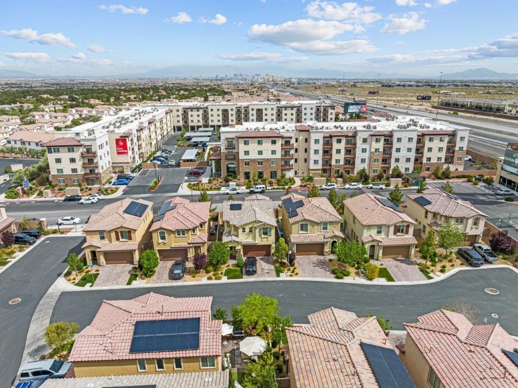 an aerial view of a neighborhood with houses and a parking lot