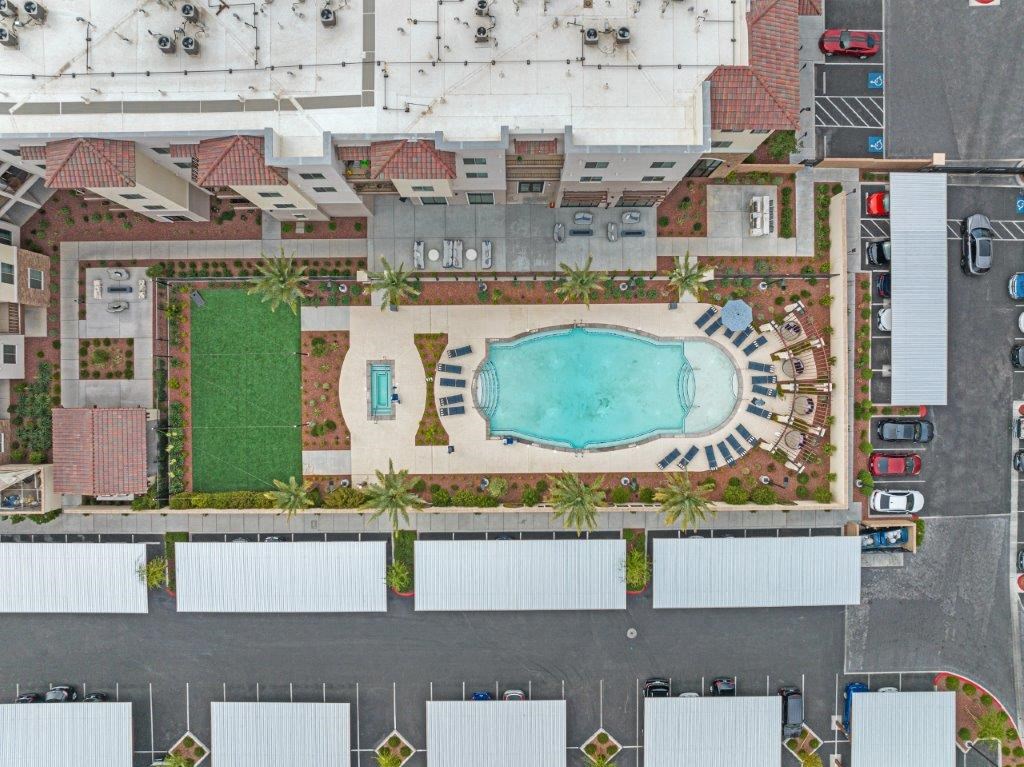 an aerial view of a pool in the middle of a parking lot