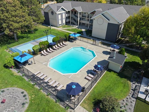 A swimming pool surrounded by a deck and a fence.