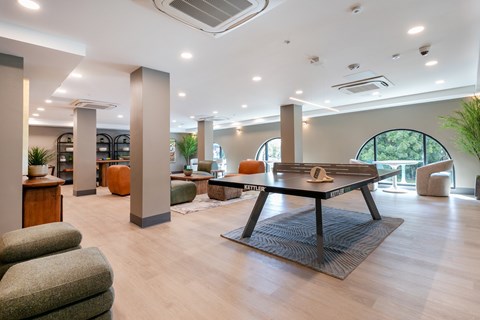 A spacious living room with a large table and chairs.