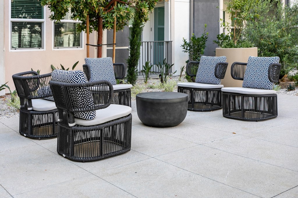 A set of outdoor furniture including a sofa, chairs and a table.