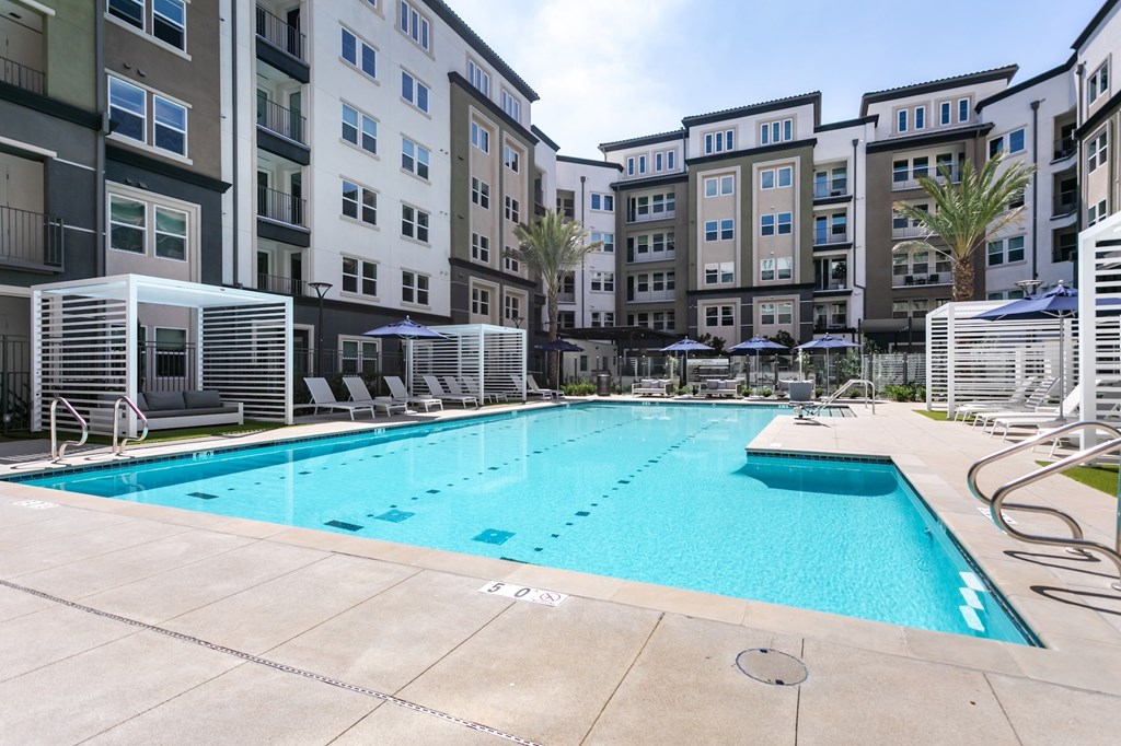 A swimming pool surrounded by apartment buildings.