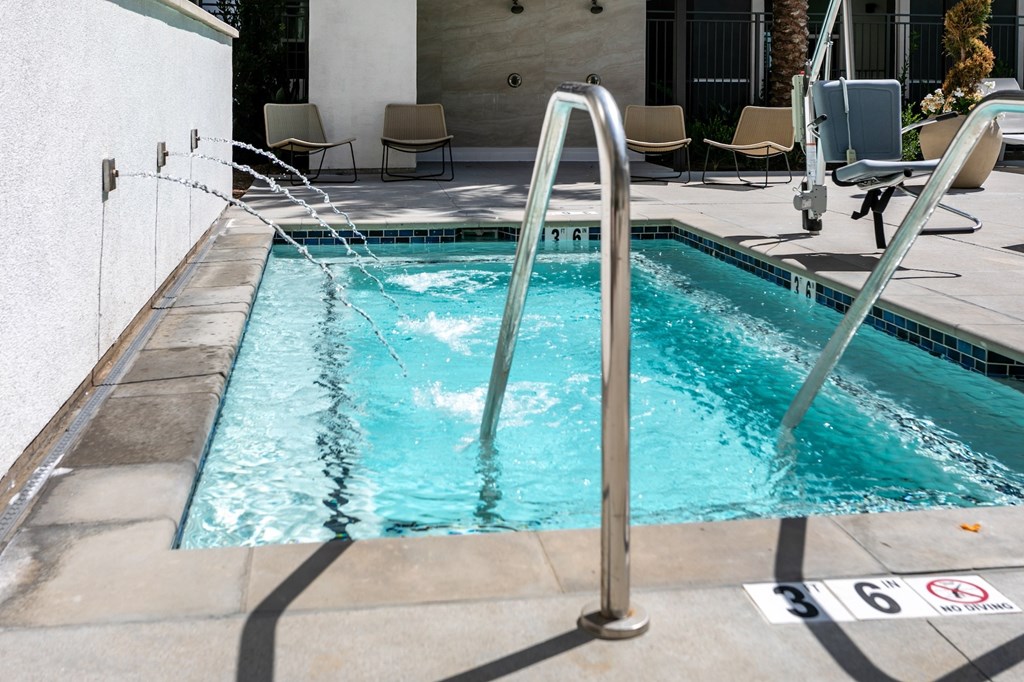 A pool with a metal ladder and a no swimming sign.