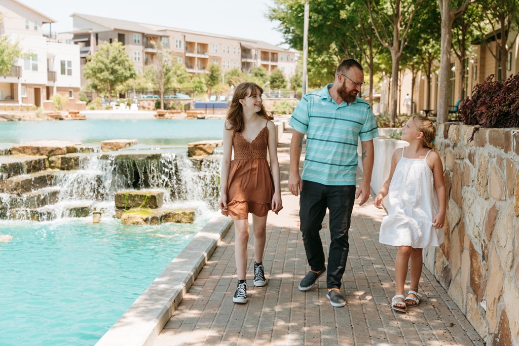 a family walking by the water fountain at the resort