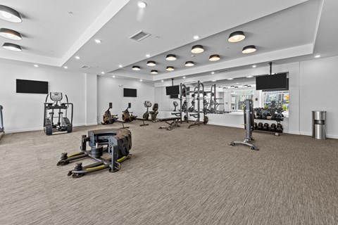 a gym with weights and other exercise equipment in a large room