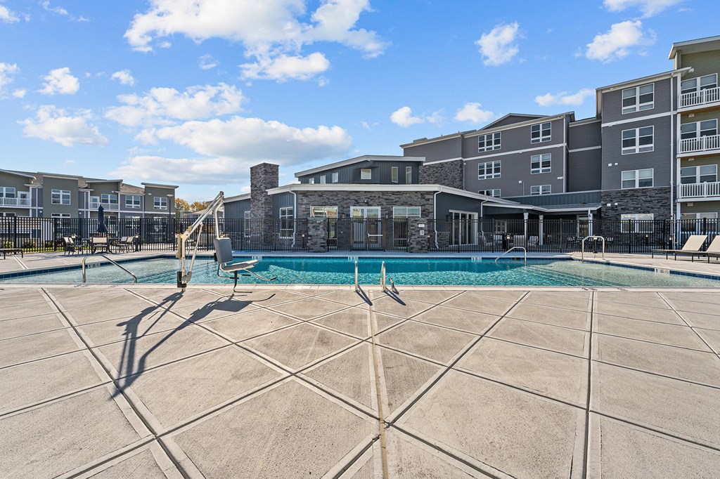 a swimming pool with an apartment building in the background
